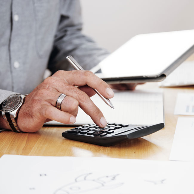 outsourced accounting professional from Optima using a calculator outsourced accounting professional from Optima using a calculator